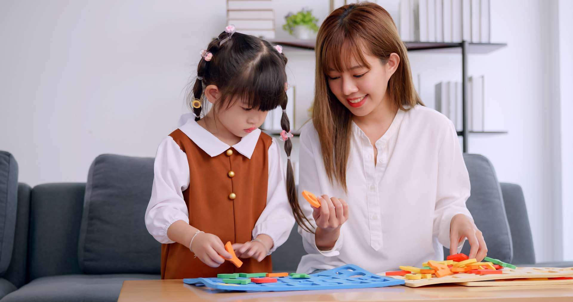 A mother and her cute daughter are enjoying spending time together at home.